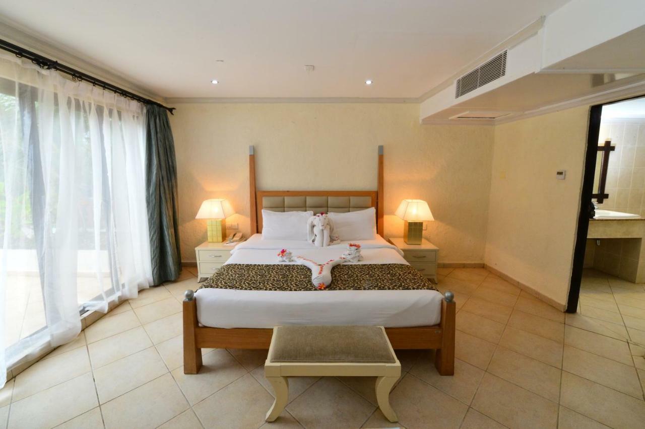 Diani Reef Beach Resort & Spa - Your Beachfront Bliss Awaits Diani Beach Exterior photo A bedroom at the hotel