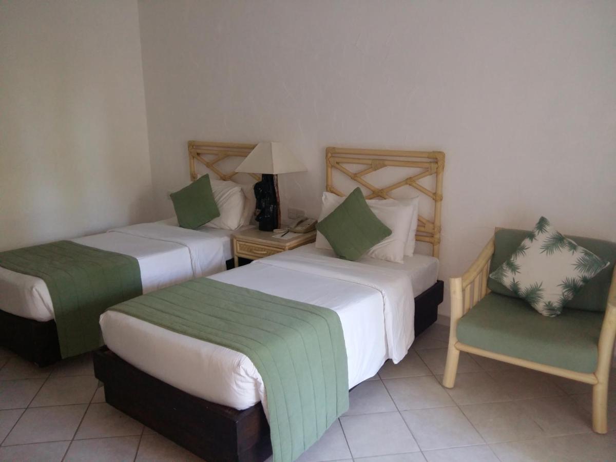 Diani Reef Beach Resort & Spa - Your Beachfront Bliss Awaits Diani Beach Exterior photo A room at the hotel